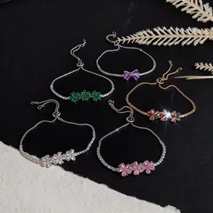 Detailed view of 18k gold plated flower and bow zircon bracelets in various colors.