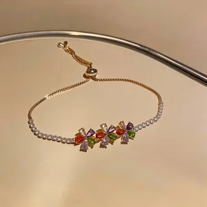 Detailed view of an 18k gold plated bracelet featuring vibrant multicolored zircon flowers