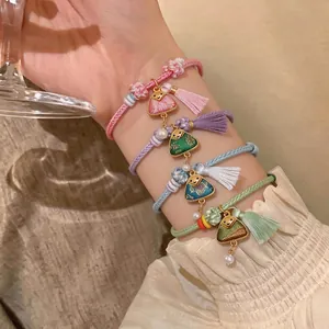 Handmade woven Dragon Boat Festival bracelets with colorful tassels and triangle charms