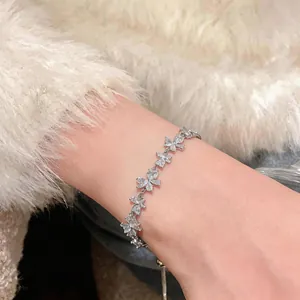 Close-up of elegant flower zircon bracelet on wrist with fuzzy sweater background