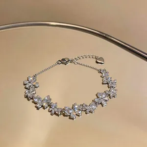 Close-up of sparkling butterfly-shaped zirconia bracelet on reflective surface