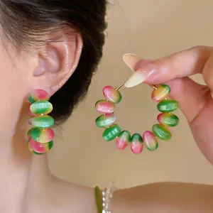 Detailed close-up of macaron gradient beaded hoop earrings in vibrant Dopamine style