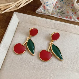 Vintage-style cherry drop earrings with red and green enamel and gold-tone finish