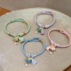 Detailed view of hand-woven Dragon Boat Festival bracelets with Zongzi charms and tassels