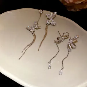 Luxury sparkling asymmetric butterfly tassel earrings with elegant bow and drop stone design