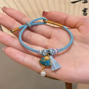 Hand-woven light blue bracelet with a cute triangle charm and tassel detail for women