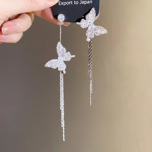 Elegant asymmetric silver butterfly earrings with long sparkling rhinestone tassels