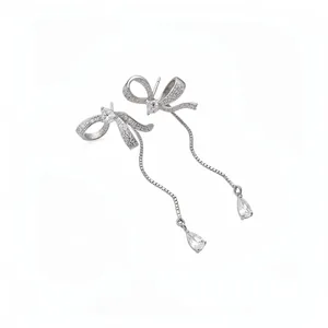 Elegant silver asymmetric bow tassel earrings with sparkling crystals for women