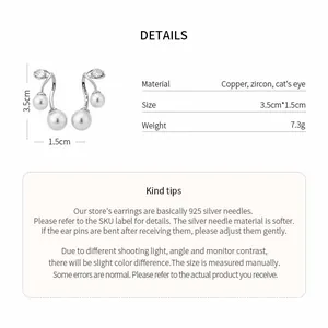 Detailed view of cat's eye and zircon earrings with material and size specifications.