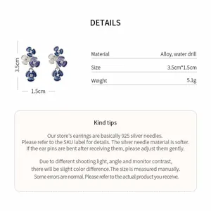 Macro view of blue floral drop earrings with detailed size weight and material specifications