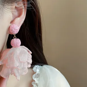 Detailed view of handmade pink raffia and chiffon flower petal drop earrings for women