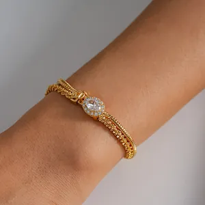 Close-up of 18k gold plated double layer bracelet with oval zircon centerpiece