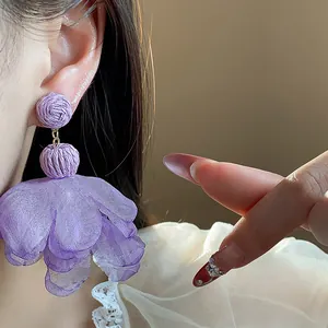 Detailed close-up of elegant lavender raffia and purple chiffon flower drop earrings