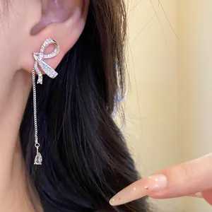 Detail shot of elegant bow tassel earrings featuring sparkling heart and water-drop stones