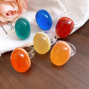 Detailed view of colorful resin oval rings with a cat-eye effect on clear bands