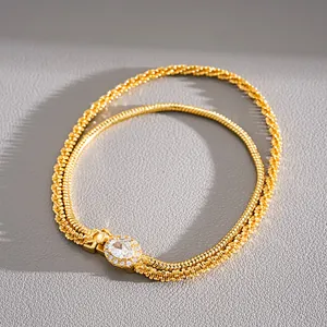 Close-up of gold-plated double-layer bracelet with sparkling oval zircon centerpiece.