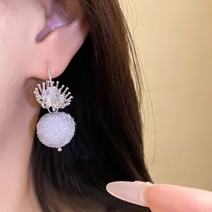 Elegant crystal flower and fuzzy white pom-pom drop hook earrings for a stylish look