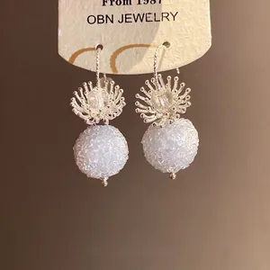 Elegant crystal flower drop earrings with white textured round beads for stylish women