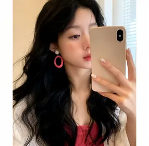 Close-up of model wearing oversized pink dopamine-style oval earrings for women