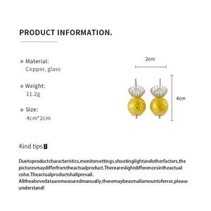 Detailed product specifications of yellow round drop earrings with flower accents