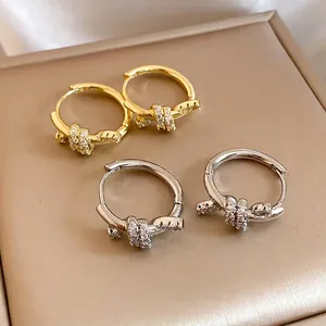 Elegant 14k gold plated knot hoop earrings featuring sparkling cubic zirconia stones