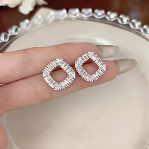 Macro view of elegant French-style diamond-shaped earrings with sparkling cubic zirconia