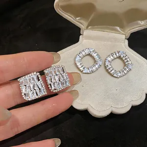 Close-up of sparkling cubic zirconia stud earrings in square and round shapes
