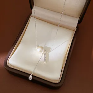 Detailed view of an elegant pearl and zircon necklace in a classic jewelry box