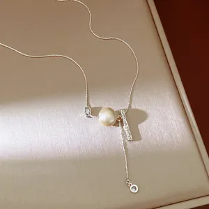 Detailed close-up view of a silver chain necklace with a unique textured champagne bead