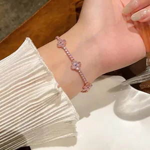 Dettaglio di un elegante bracciale in oro rosa con quadrifogli scintillanti in zircone rosa.