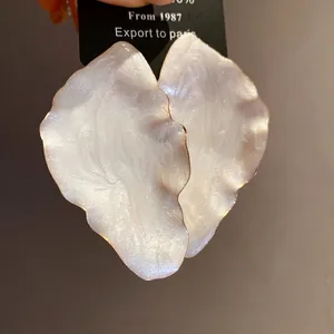 Elegant vintage pearlescent white enamel leaf stud earrings with refined gold metallic edges