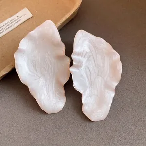 Elegant vintage leaf-shaped earrings with pearlescent white enamel and gold trim
