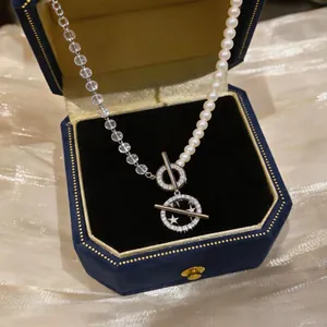 Close-up of zircon pearl beaded necklace with star pendants in a luxury box