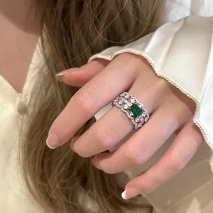 Elegant detail shot of a vintage hollow ring with a radiant square emerald green zircon