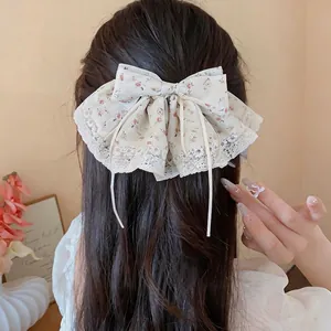 Elegante bloemen stoffen strik haarclip met kant en lange linten voor dames