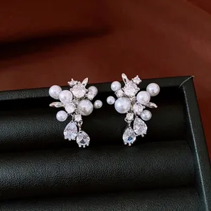Elegant silver stud earrings featuring pearls and teardrop zircons in a floral design