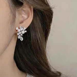 Elegant butterfly waterdrop earrings with zircons and pearls on a silver needle base.