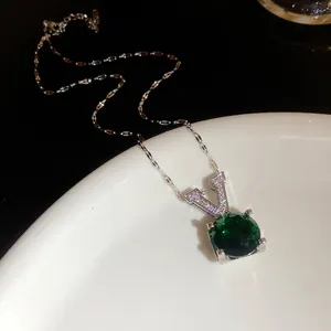 Vue détaillée du collier pendentif V en argent avec pierre verte facettée et zircons