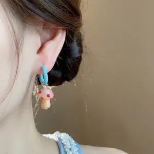 Exquisite handmade glass mushroom hoop earring featuring pink spotted cap and blue hoop