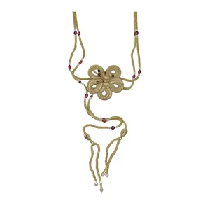 Handmade resort style necklace featuring woven gold flower detail and red glass beads.