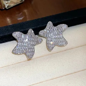 Detailed macro view of sparkling star-shaped stud earrings with full zircon inlay.