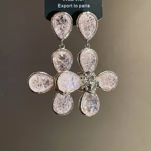 Elegant silver drop earrings featuring pink crackled resin flower petals macro detail
