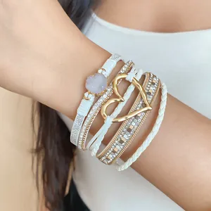 Elegant multi-layer white leather wrap bracelet featuring gold heart charm and crystal accents
