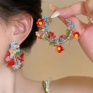 Ethnic colorful beaded flower hoop earrings with silver pins for women.