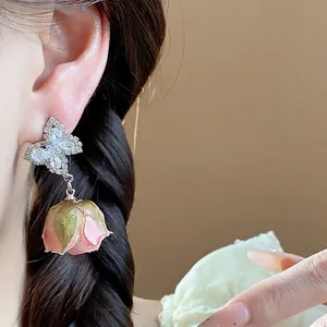 Elegant sterling silver zircon butterfly earrings with preserved pink rose bud drops