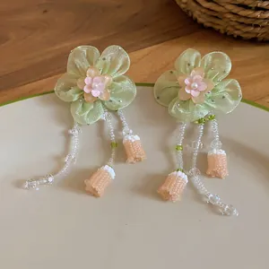 Detail of handmade organza flower earrings with beaded tassels and pearls.