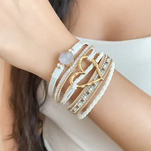 Detailed view of bohemian white multi-layer wrap bracelet featuring a druzy stone and gold heart