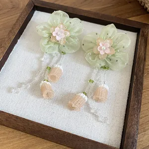 Handmade green organza flower drop earrings with elegant beaded tassels and floral accents
