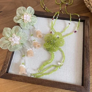 Detailed view of handmade green beaded flower necklace and earring set
