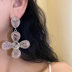 Macro view of elegant flower drop earrings with pink cracked resin and silver-tone finish
